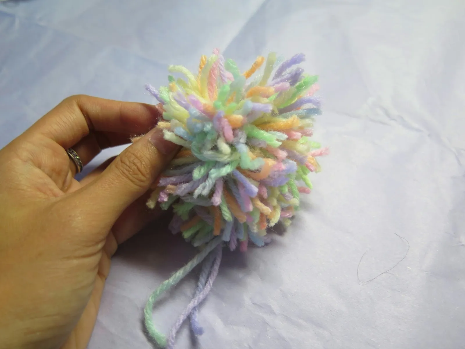 A yarn pompom before trimming