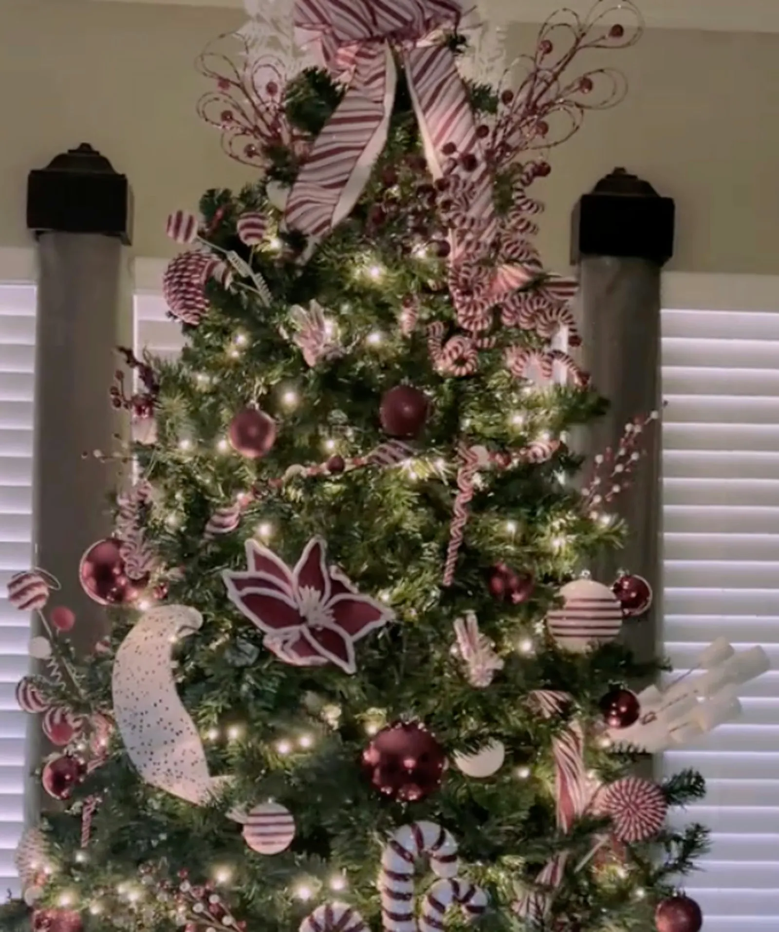 Green Christmas tree with red and white decorations