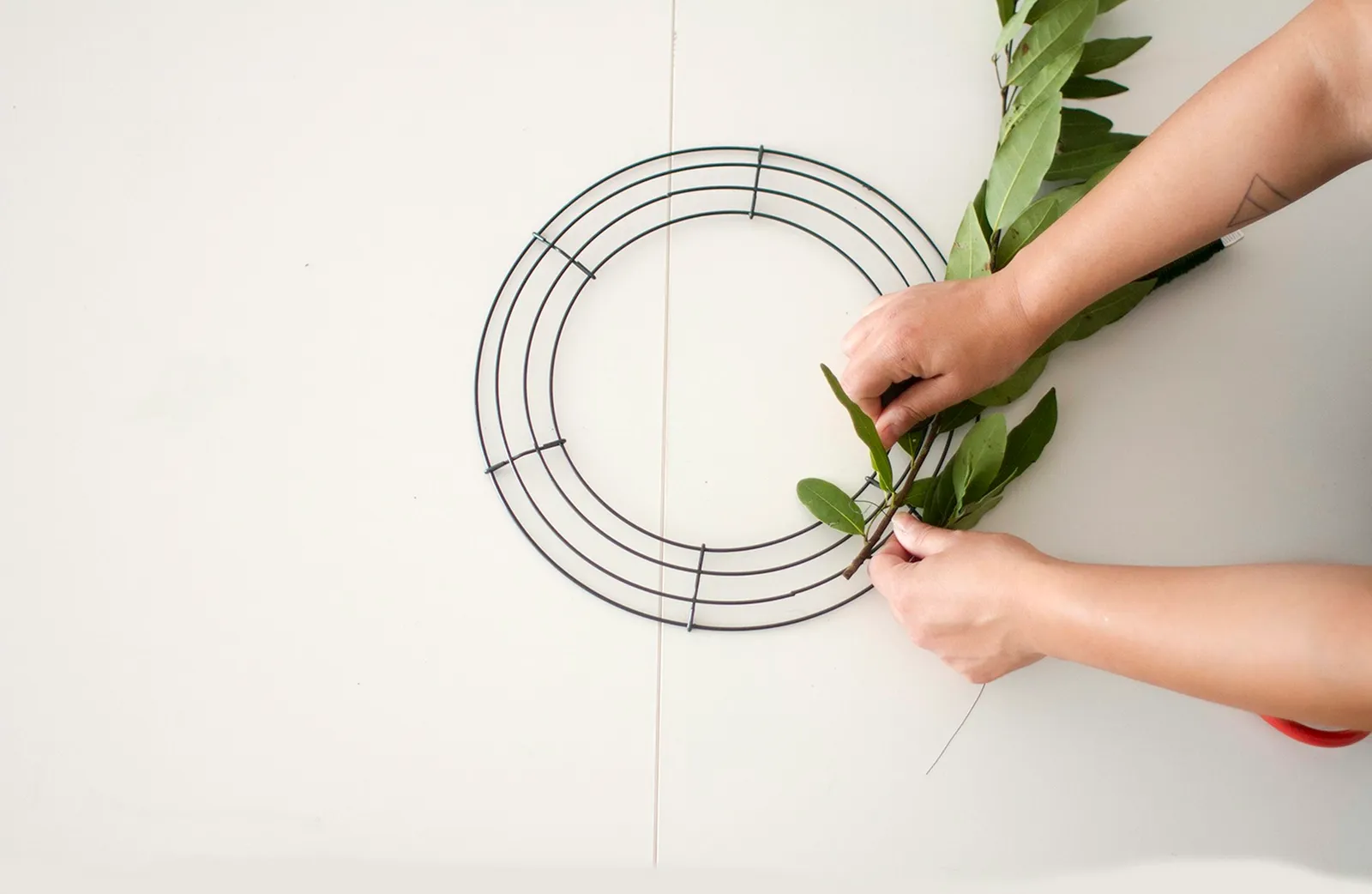 Tie olive greens to wreath