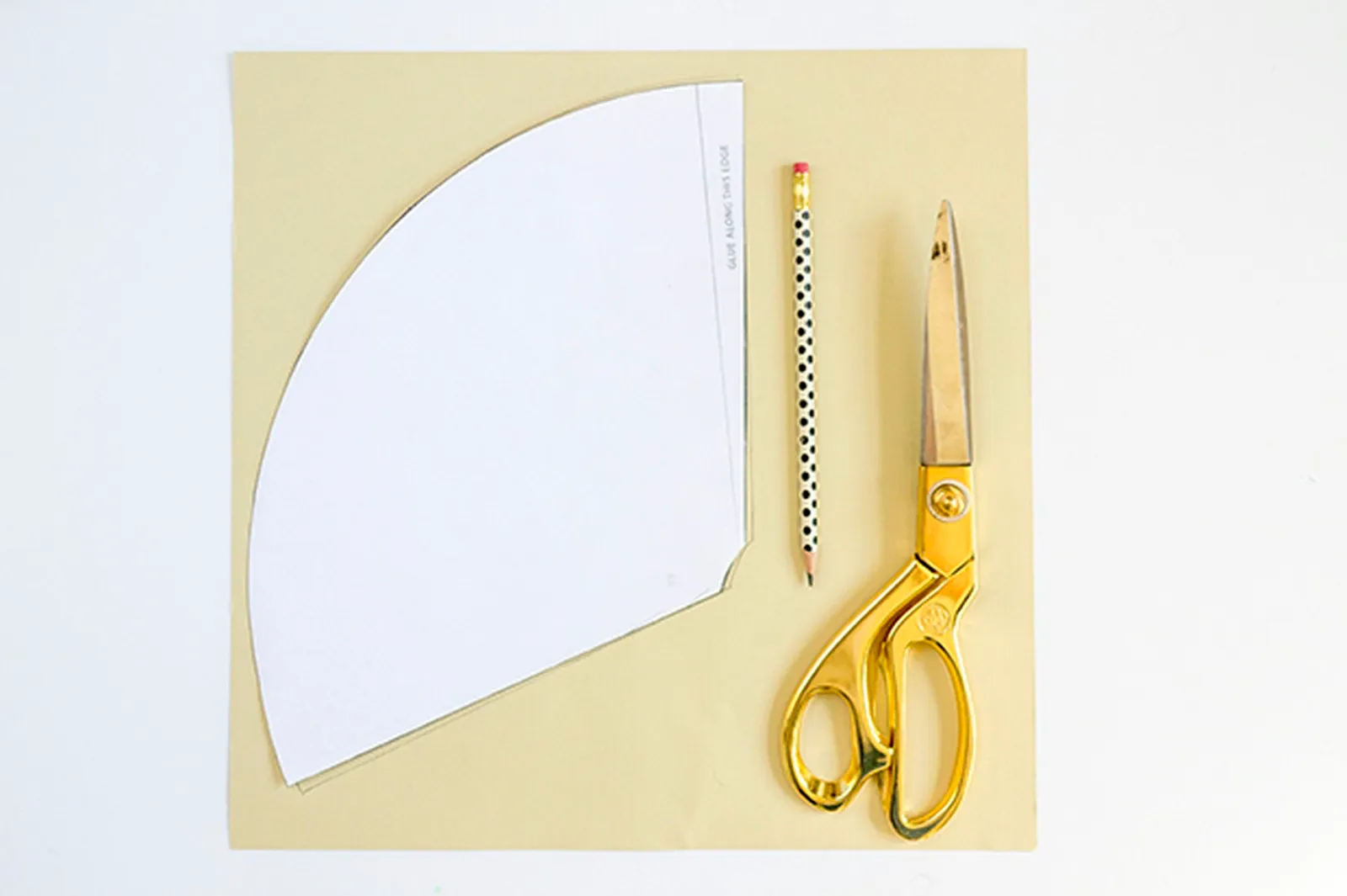 Retrace the paper hat template onto a piece of cream-colored cardstock paper.