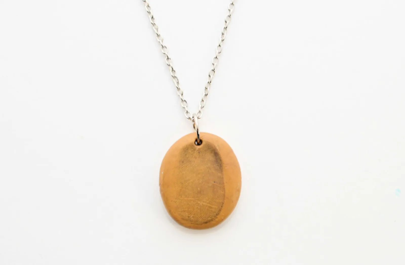 To protect your pendant, you can apply a layer of clear nail polish or decoupage glue..