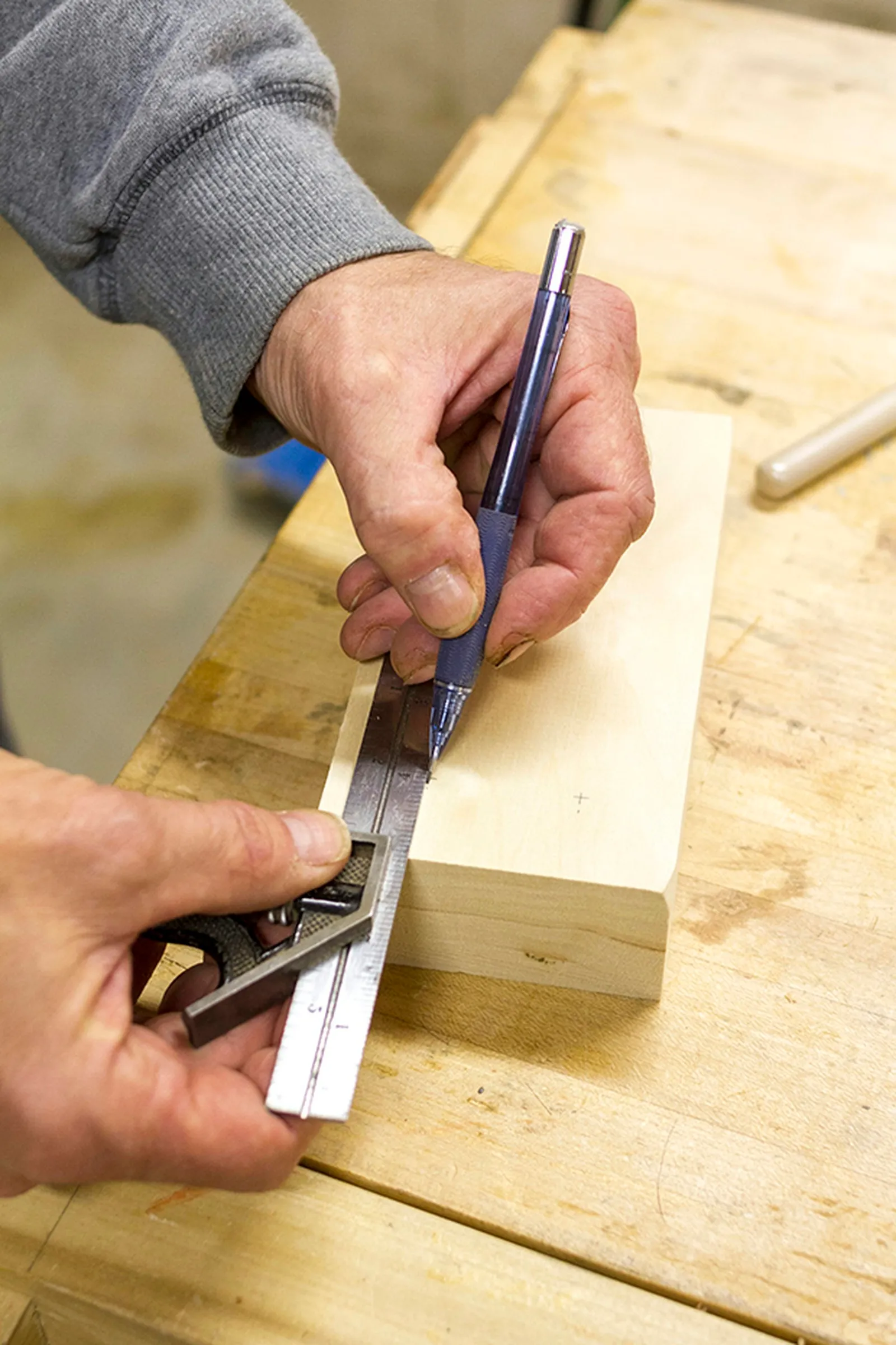Use a ruler and pencil to make marks on the wood where the holes will go.