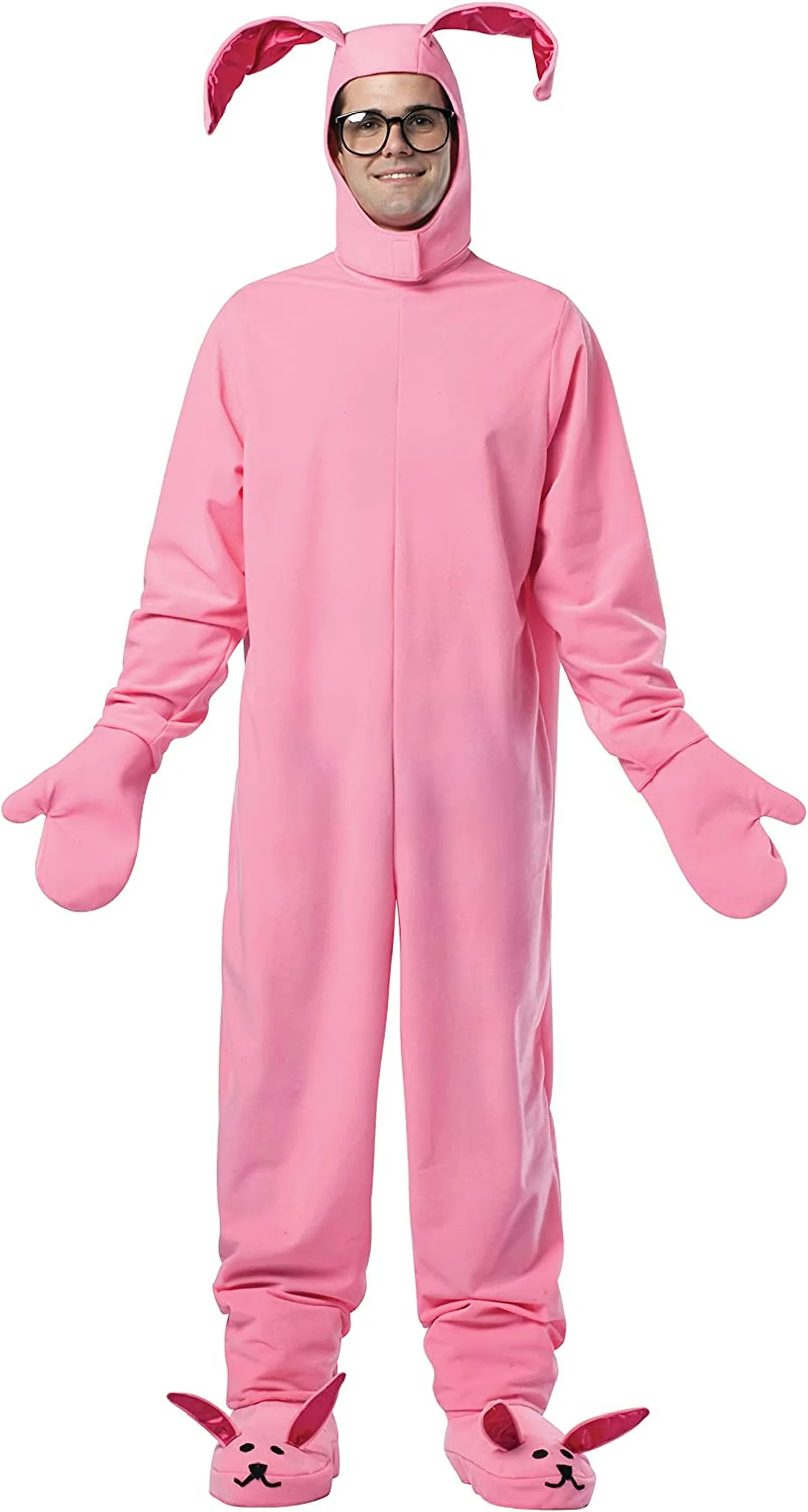 A man with glasses wears a bright pink onesie with bunny ears, mitten hands and bunny feet.