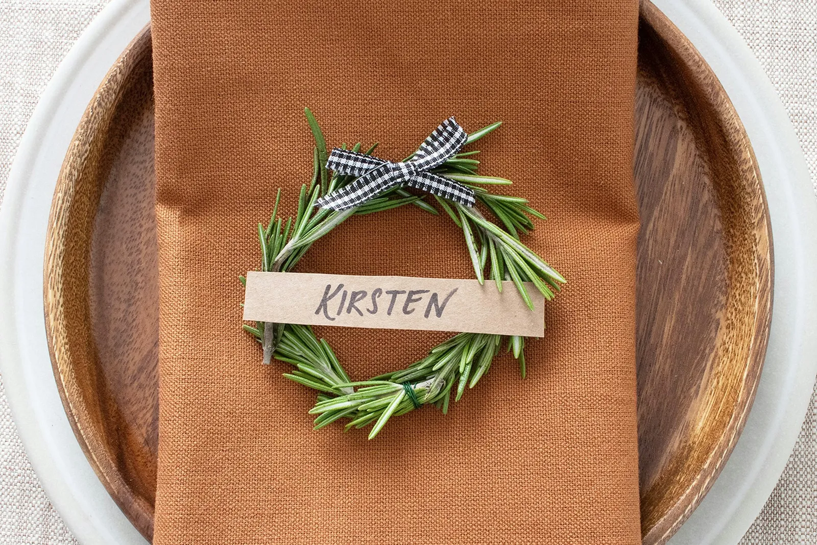 Mini rosemary wreath place card on napkin and plate