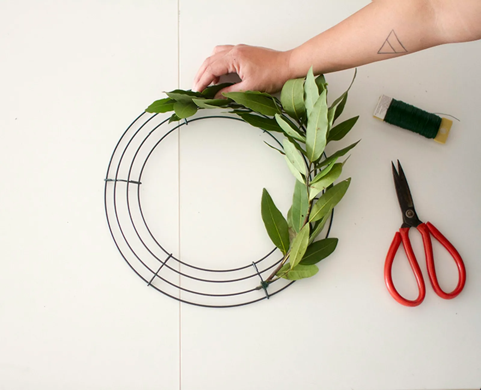 Wrapping olives greens to make a wreath
