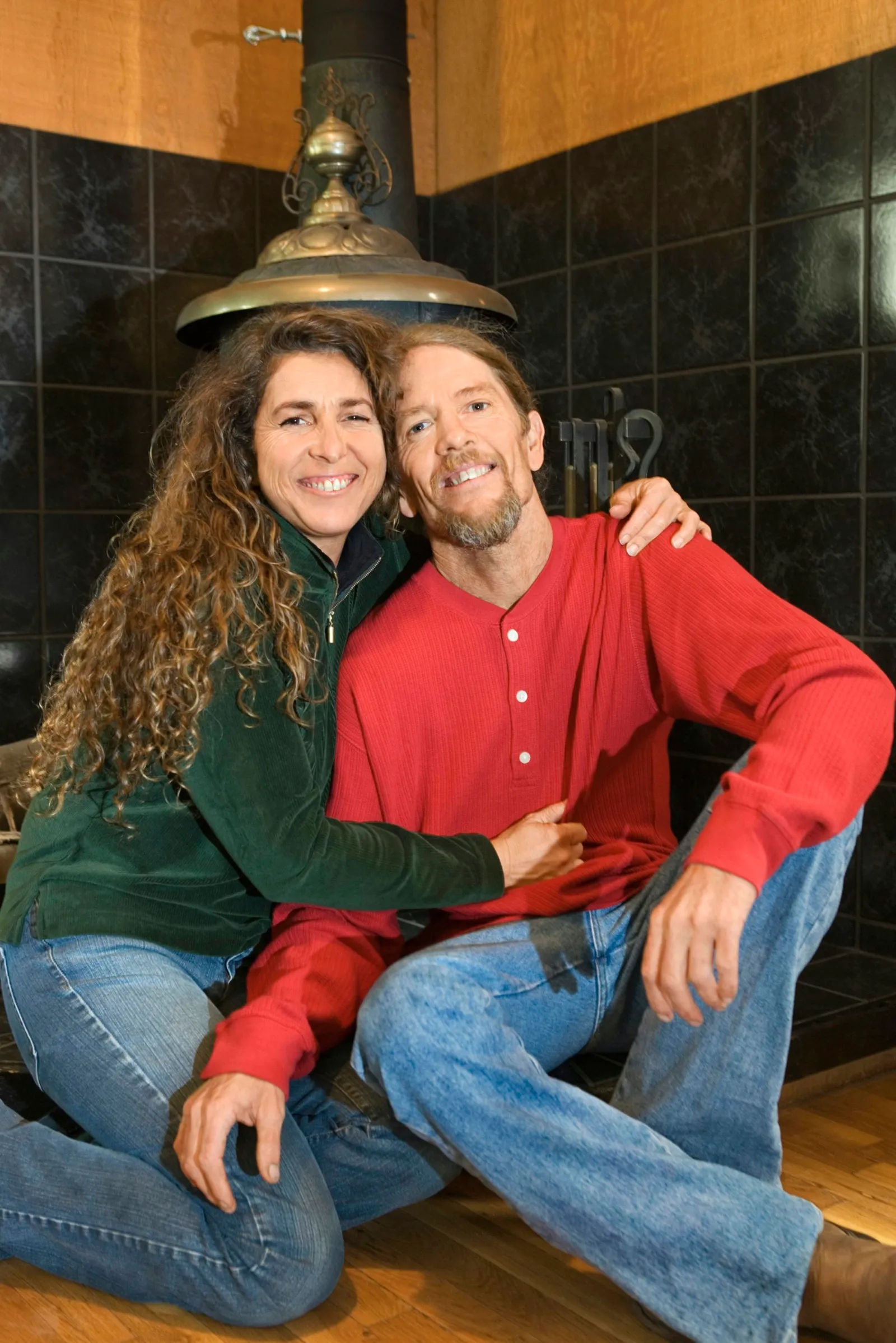 Couple sitting by wood stove