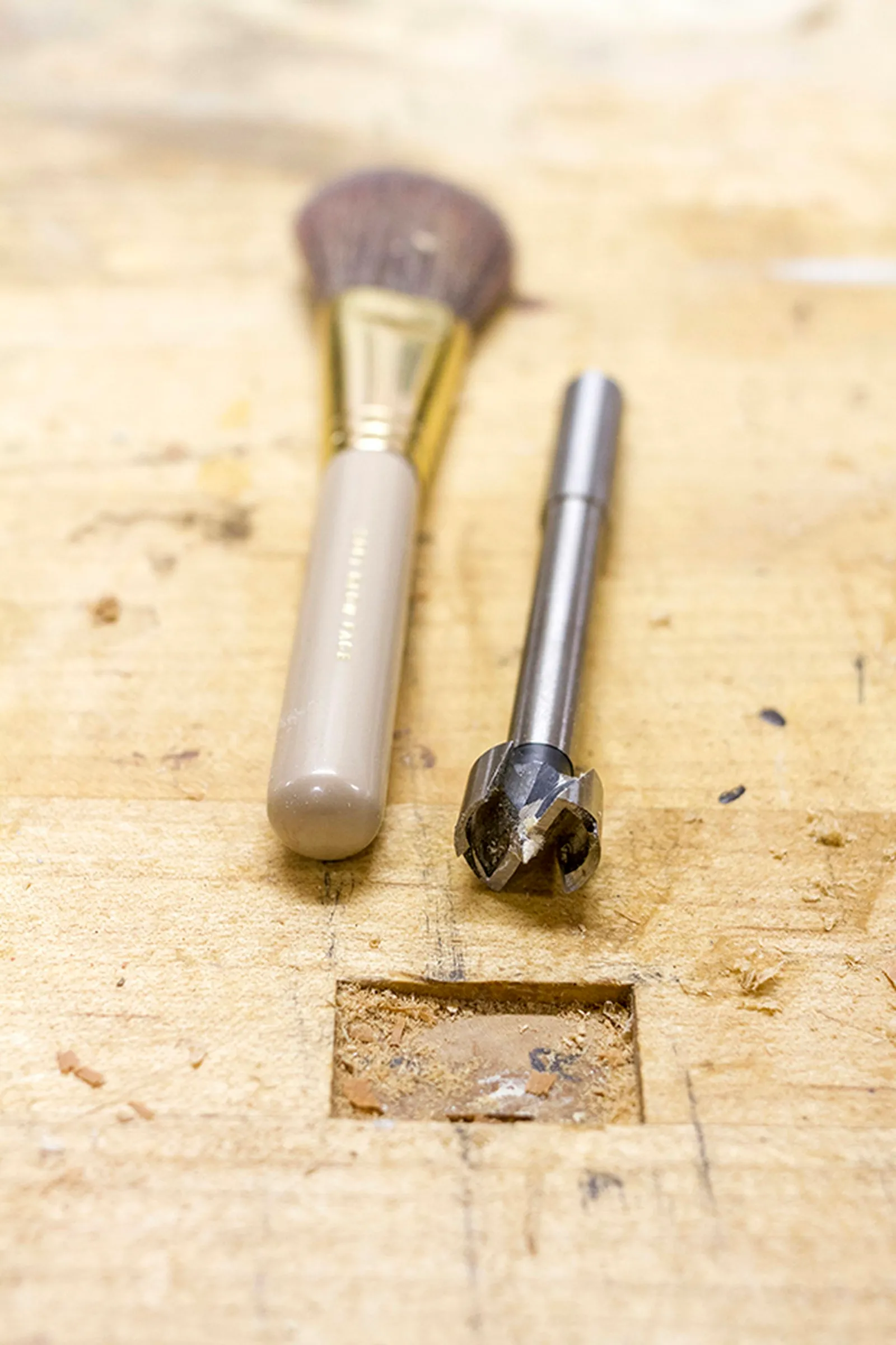 Measure the diameter of your thickest makeup brush and then find a bit to match.