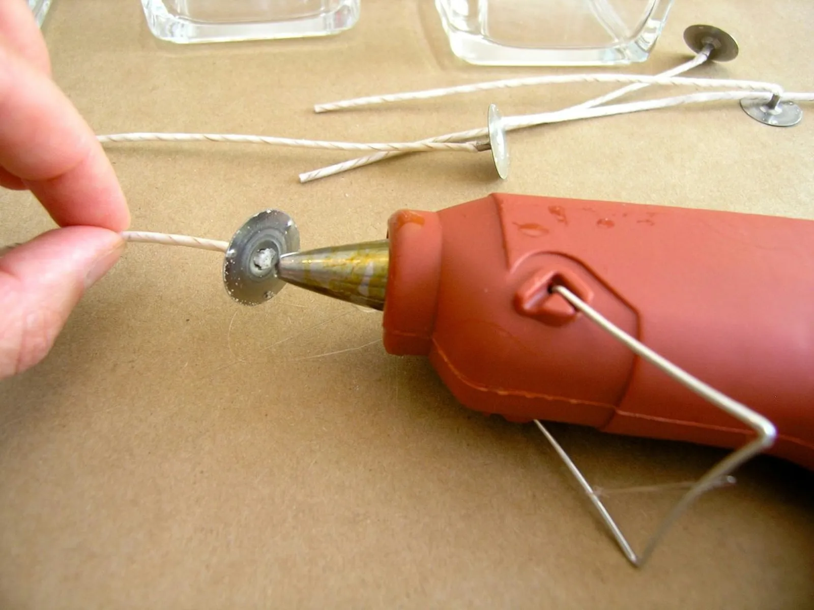 Glue wicks to the bottom of the container.