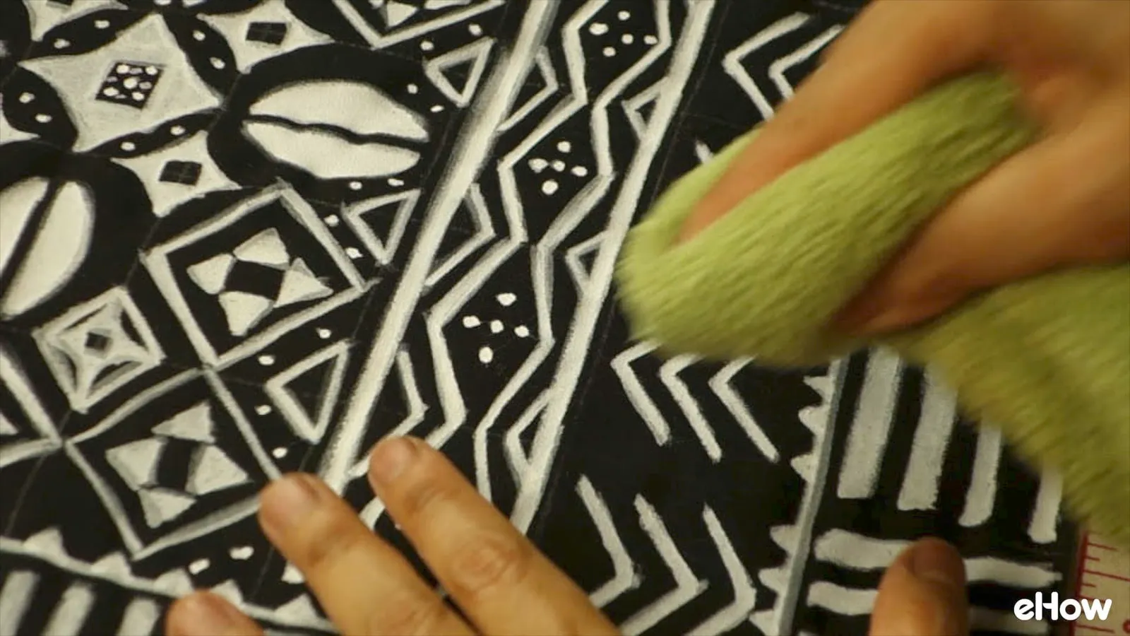 Erasing chalk marks from DIY mudcloth-inspired wall hanging.