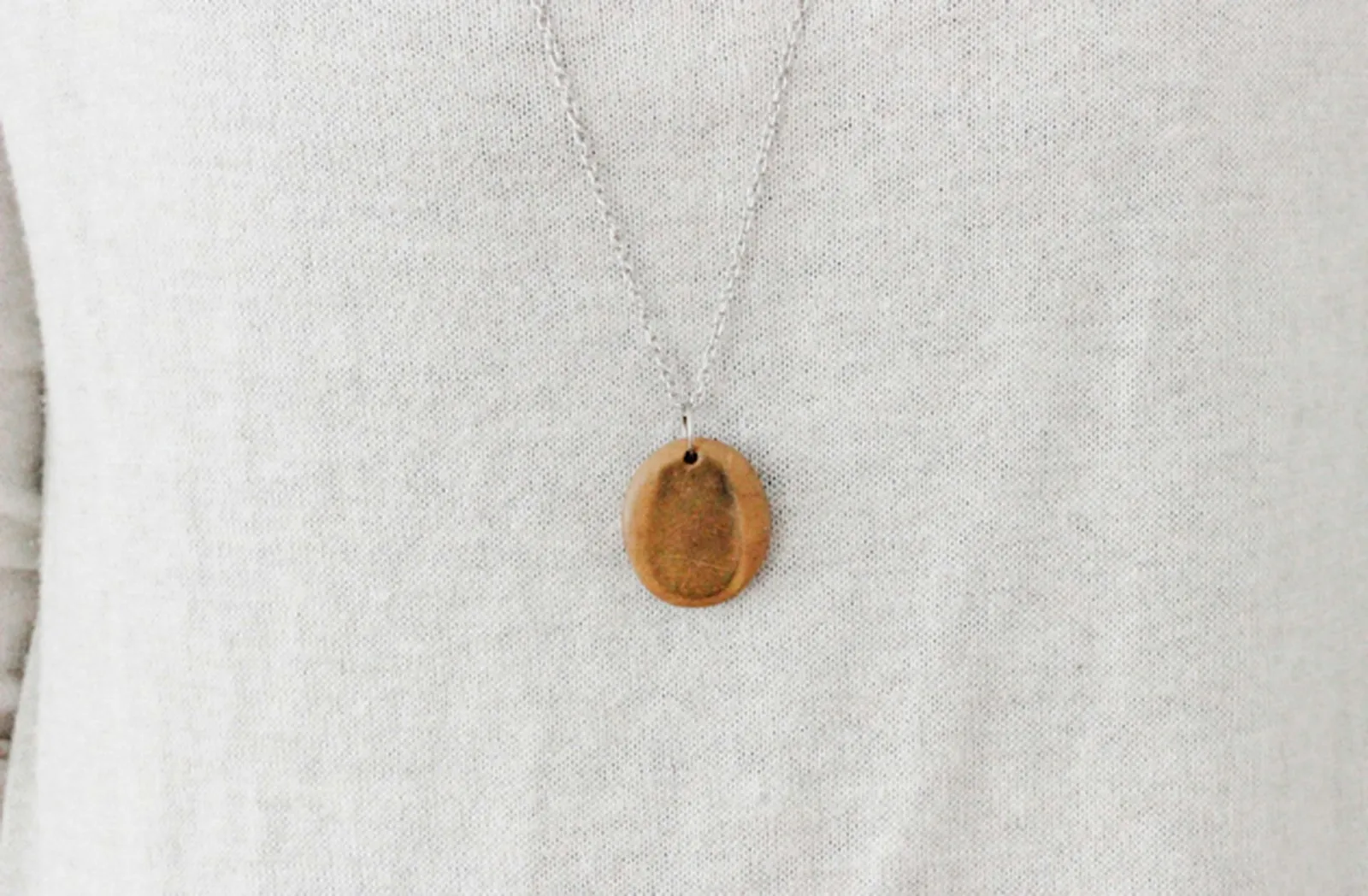Make a momento from a special someone with a clay thumbprint necklace.