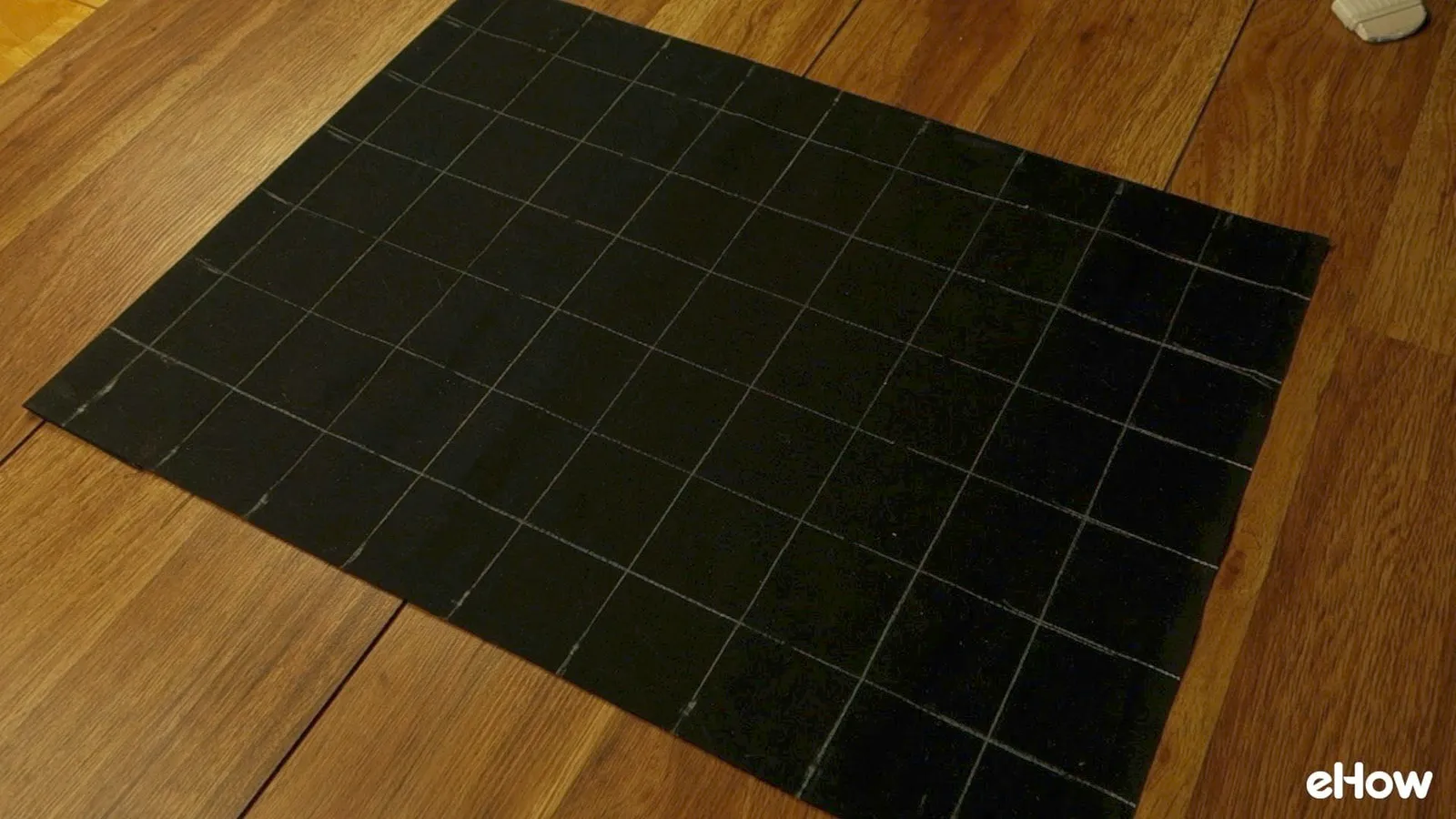 Drawing chalk guidelines for DIY mudcloth-inspired wall hanging.