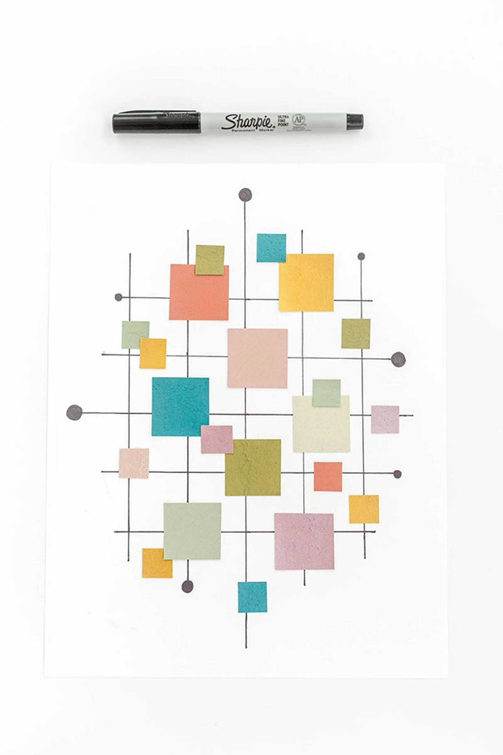 Finish by adding a few extra cut paint chips and small circles at the edges of the grid.