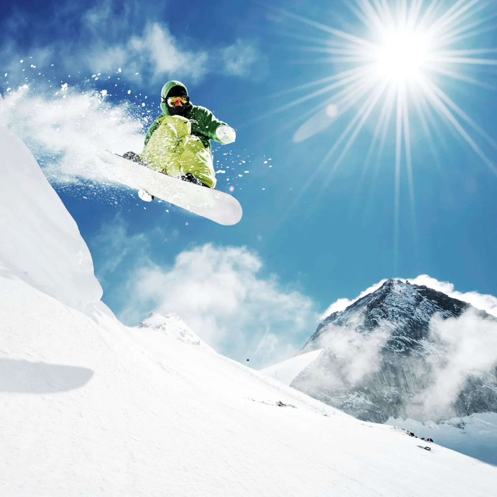 Snowboarder at jump in high mountains