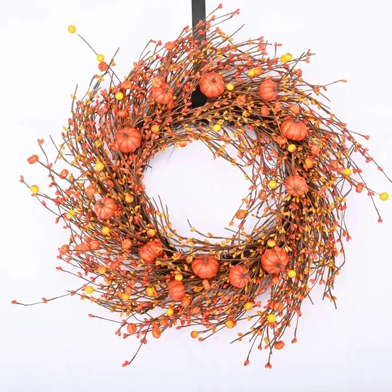 Pumpkin Berry Floral Wreath from Wayfair in orange. It has little faux pumpkins and orange and yellow berries and many whispy branches.