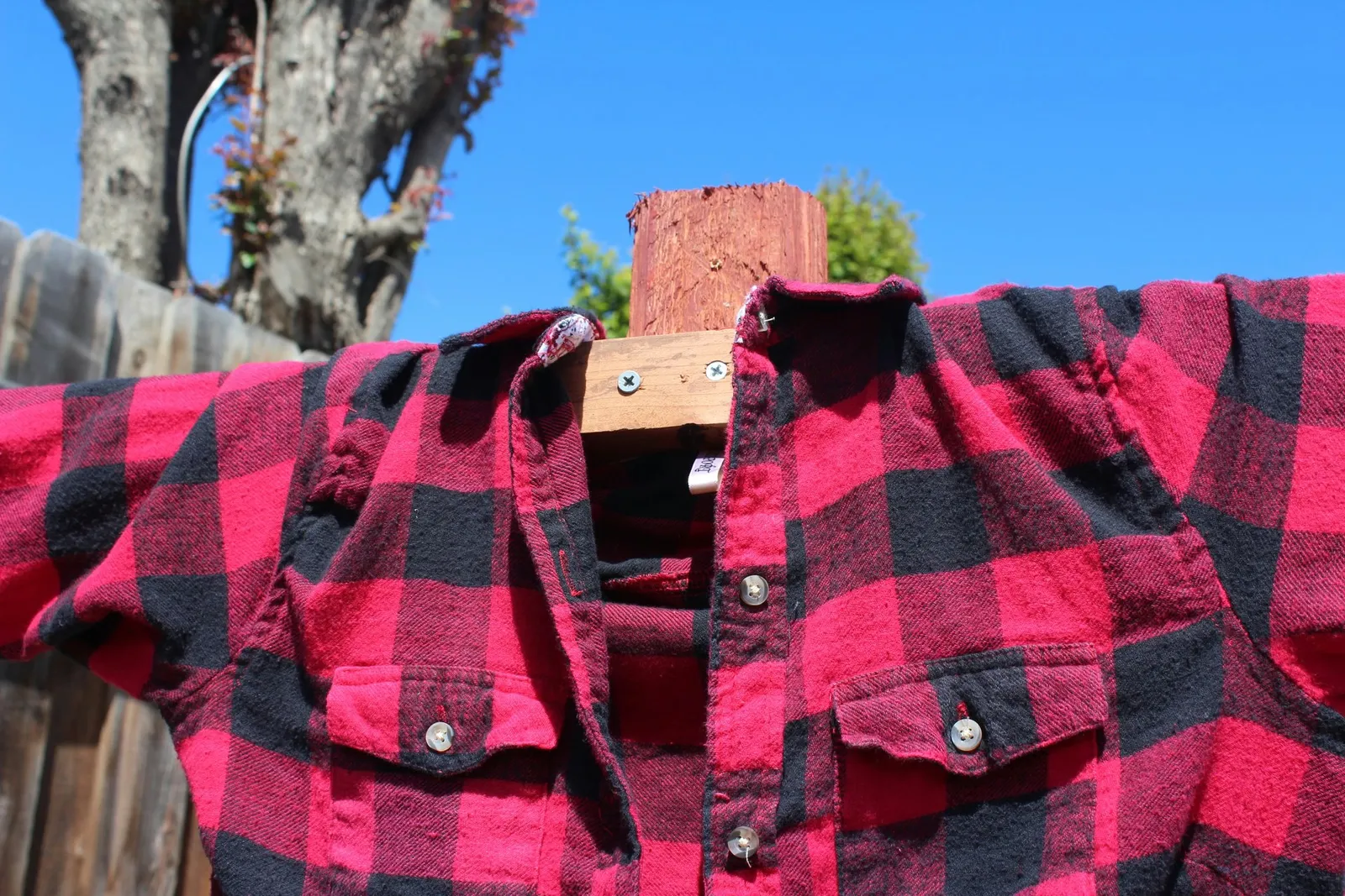 Wood and shirt attached to post
