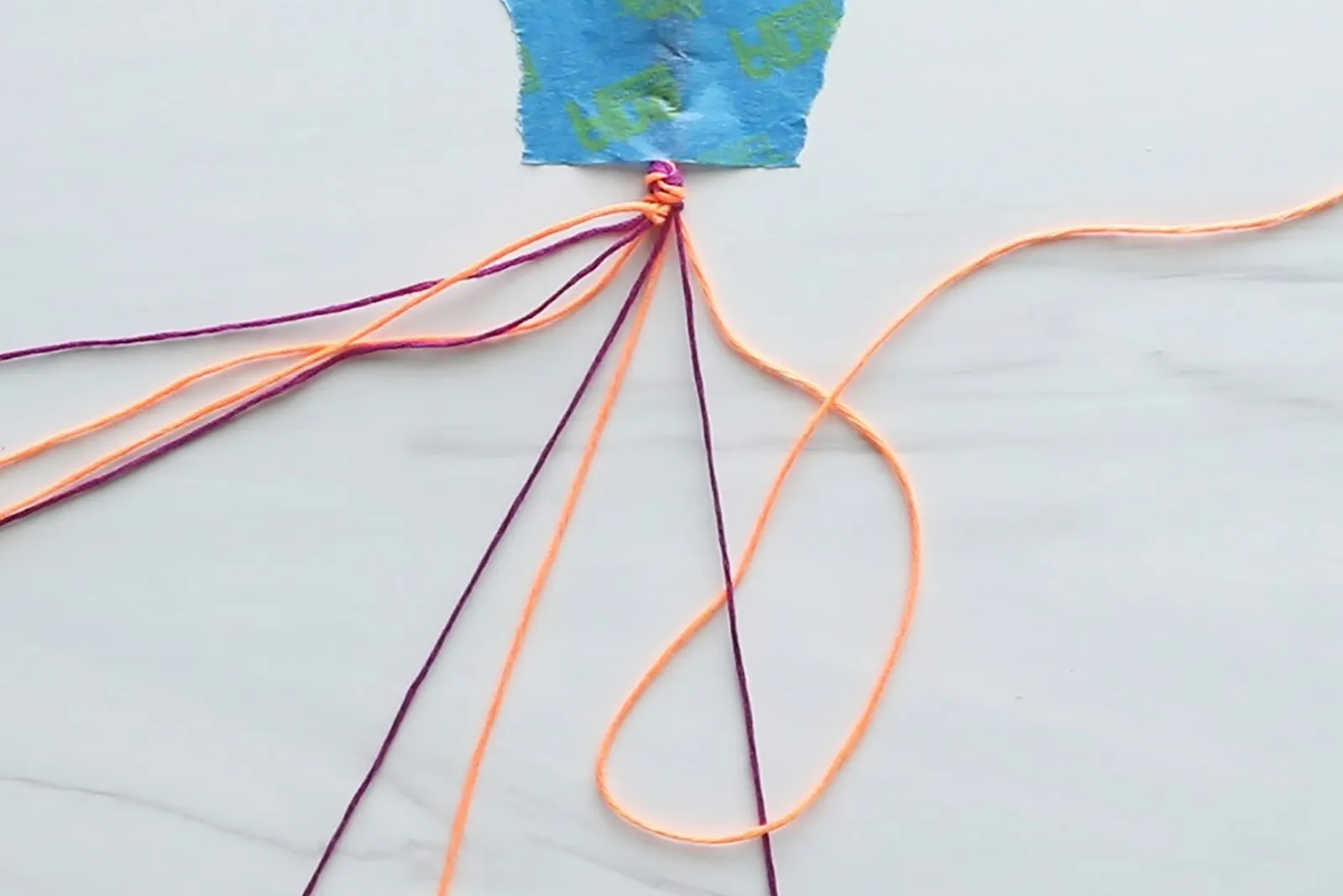 Knotting embroidery thread for a heart friendship bracelet