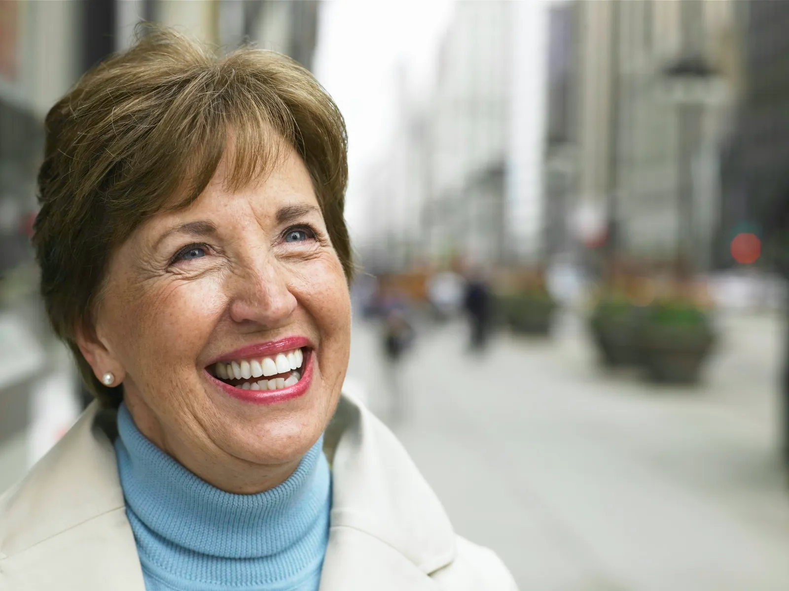 Senior woman standing on sidewalk
